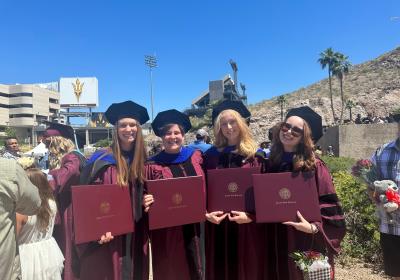 Graduation photo of Erin Murphy, Liz Dietz, Anna Guererro and Dina Z holding diplomas