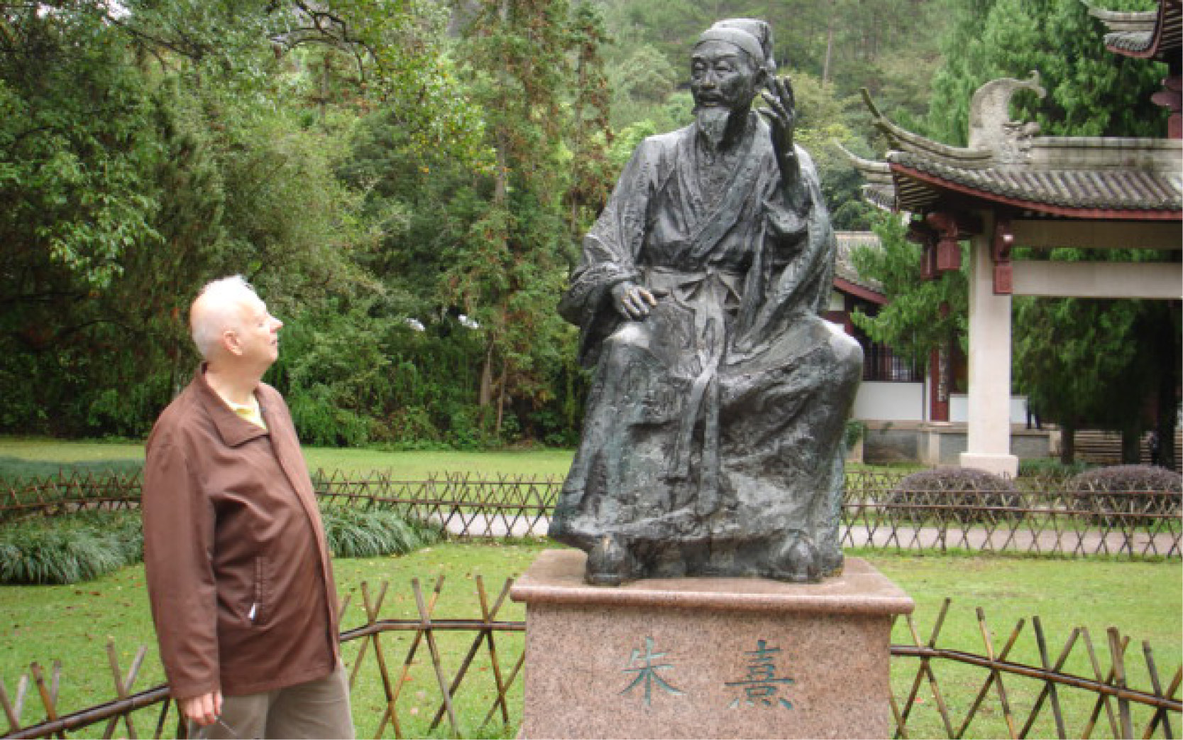 professor standing with statue