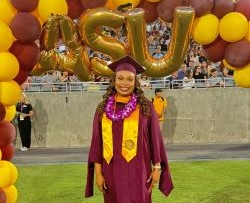 Photo of Ilani under the balloon arch