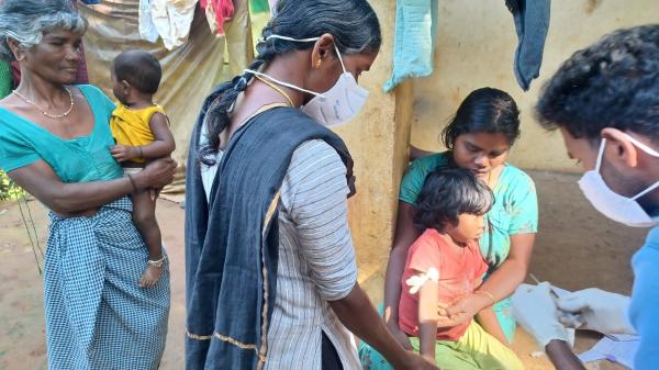 Community Health Workers from a community-run hospital collecting a blood sample from a child with sickle cell disease for routine testing of hemoglobin levels