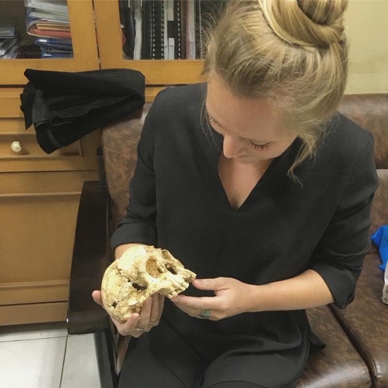 Photo of Paige with the skull of Homo floresiensis.