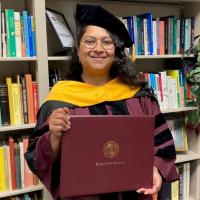 Photo of Sangha holding her diploma