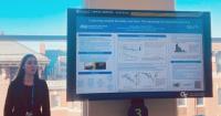 Photo of Ava Claus presenting her eposter at AAAS 2025