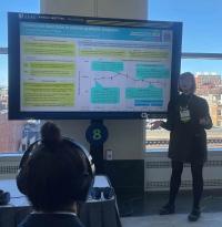 Photo of Jynx Pigart presenting her eposter at AAAS 2025