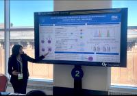 Photo of Sara Korpe presenting her eposter at AAAS 2025