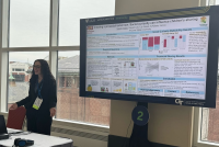 Photo of Sarah Nesbit presenting her eposter at AAAS 2025