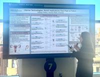 Photo of Aubrey Pinteric presenting her eposter at AAAS 2025