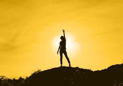Photo of a person on a hill with giving the pitchfork symbol